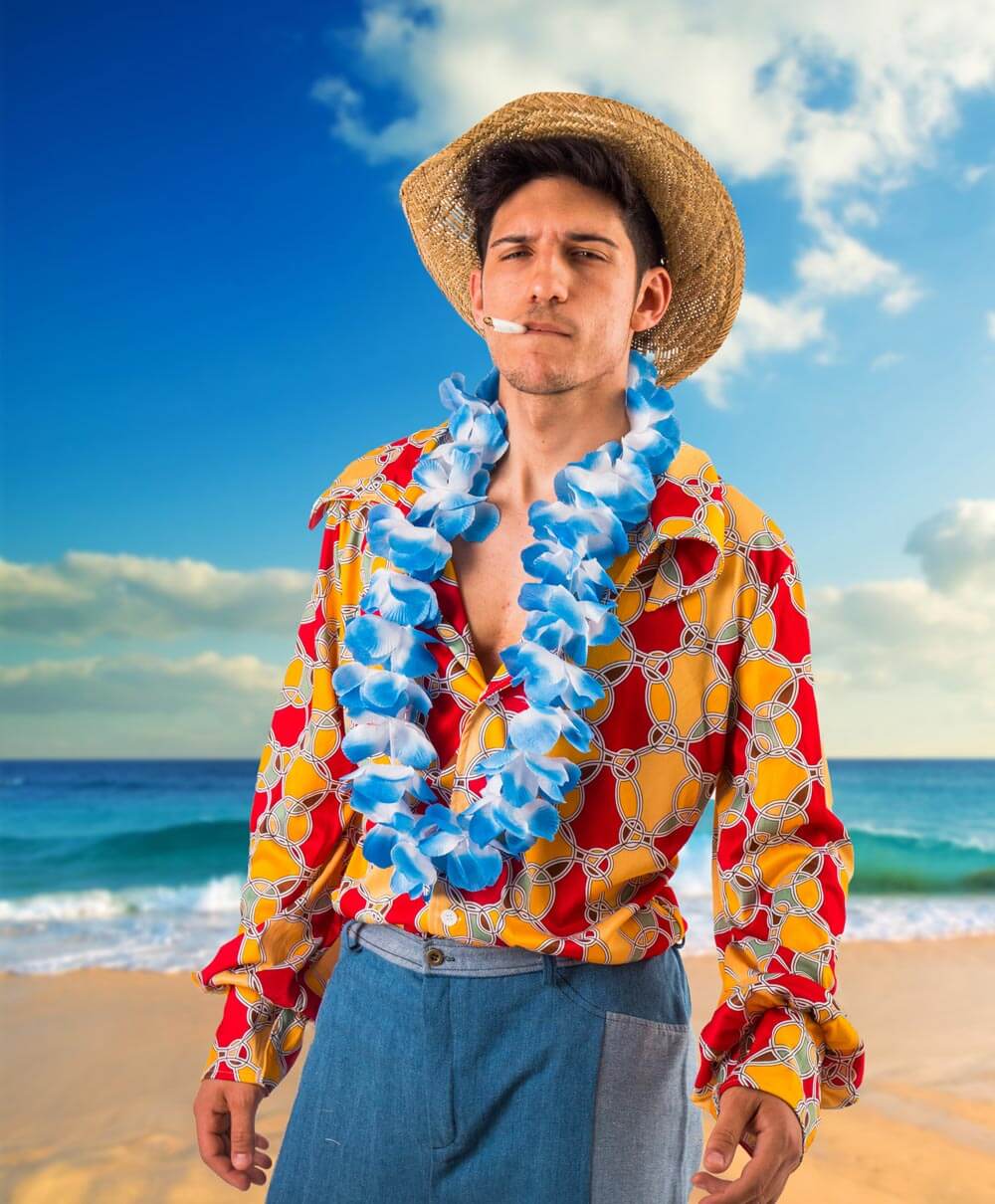 Model wearing a colourful beach shirt by the sea