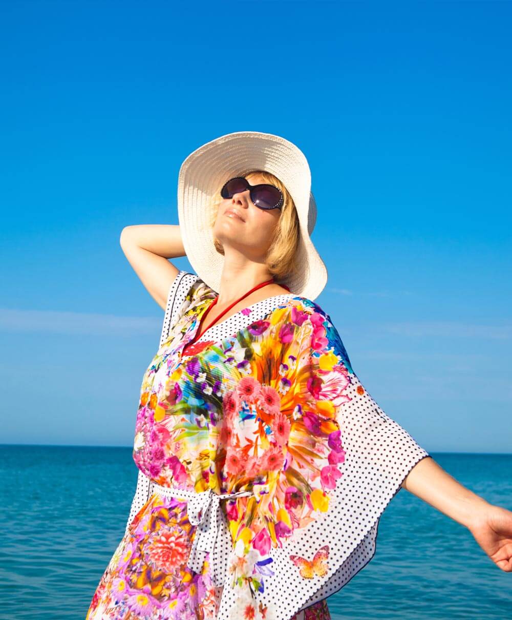 Model wearing a bright floral shirt in the sunshine
